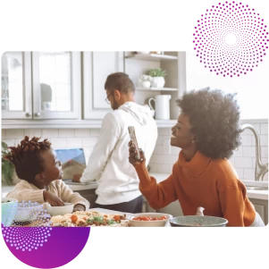 family enjoying a meal while on mobile banking app